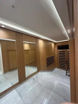 a walk in closet with wooden walls and doors at Studio lumineux pour un séjour agréable 28 in Casablanca