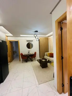 a living room with a table and a couch at Studio moderne et accueillant, pour se reposer 14 in Casablanca