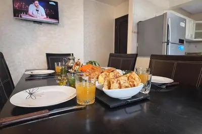 a table with a plate of food and a bowl of bread at Grand 3 pièces de standing, confort premium in Casablanca
