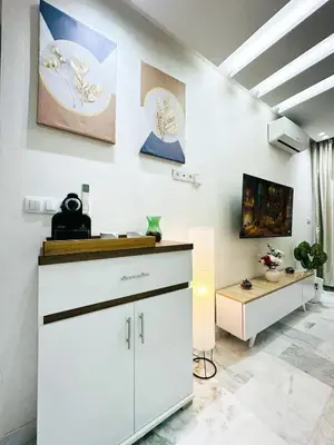 a room with a white cabinet and a table at Studio cosy et calme, idéal pour se détendre 15 in Casablanca