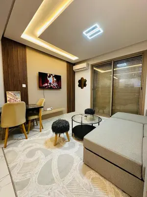 a living room with a bed and a dining room at Studio tout équipé pour un séjour confortable 22 in Casablanca