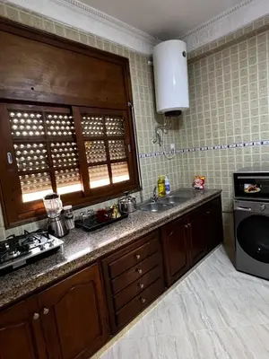 a kitchen with a sink and a stove at Appartement confortable à Rabat, idéalement situé près de la Corniche et du Stade in Rabat