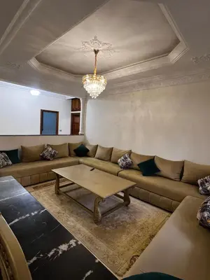 a living room with a couch and a table at Appartement confortable à Rabat, idéalement situé près de la Corniche et du Stade in Rabat