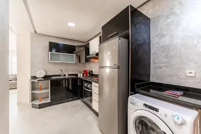 a kitchen with a refrigerator and a washing machine at Apartment in the center of Casablanca opposite the tram in Casablanca