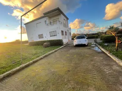 a white car parked in front of a white house at Large Villa Pool And Garden on 5200 m in Berrechid