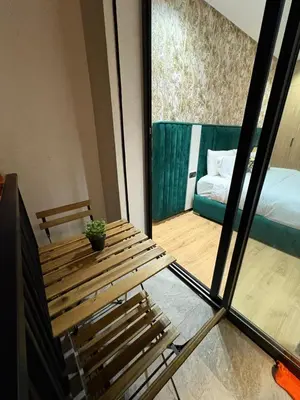 a room with a bench and a bed and a window at Beau Living Residence Central Cosy Apartment In The Heart Of Casablanca Close To Anfa Park Calm Area in Casablanca