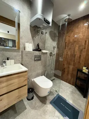 a bathroom with a shower and a toilet and a sink at Beau Living Residence Central Cosy Apartment In The Heart Of Casablanca Close To Anfa Park Calm Area in Casablanca