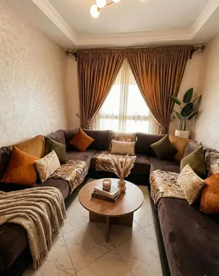 a living room with a couch and a table at Séjour économique près de la plage in Bouznika