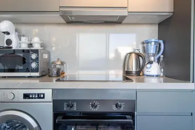 a kitchen with a stove and a microwave at Business Executive Apartment Central Casablanca in Casablanca
