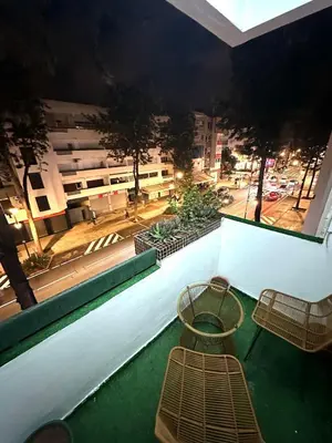 a balcony with two chairs and a view of a street at appartement au coeur de Rabat in Rabat