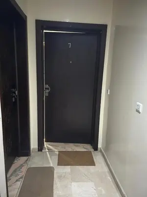 a black door in a room with a tile floor at Rihab's House in Casablanca