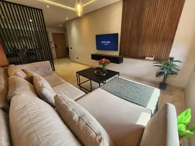 a living room with a couch and a table at Modern Studio Panoramic View with Wi-Fi et Parking in LʼOasis
