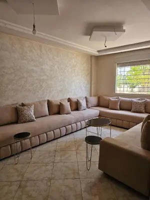a living room with a large couch and tables at Bouznika in Bouznika