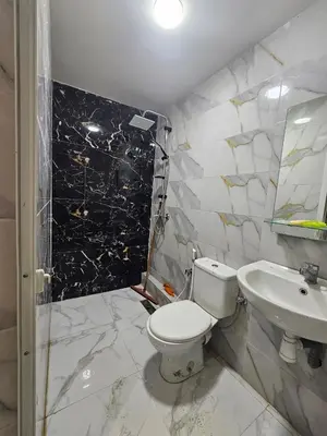 a bathroom with a toilet and a sink at Bouznika in Bouznika