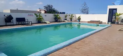 a swimming pool with blue water in front of a building at Appartement Piscine Gare Oasis in Casablanca