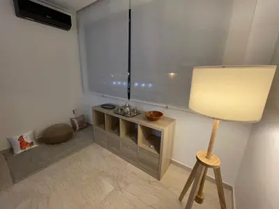 a room with a lamp and a table with atainment at Appartement Piscine Gare Oasis in Casablanca