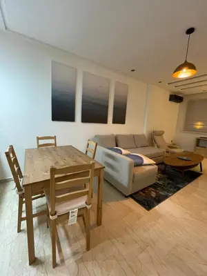a living room with a couch and a table at Appartement Piscine Gare Oasis in Casablanca