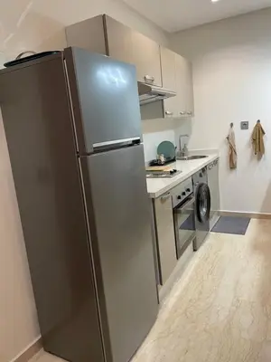 a stainless steel refrigerator in a small kitchen at Appartement Piscine Gare Oasis in Casablanca
