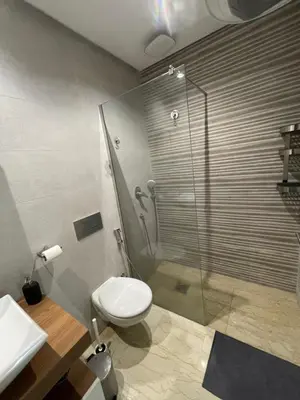 a bathroom with a shower and a toilet and a sink at Appartement Piscine Gare Oasis in Casablanca