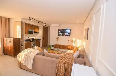 a living room with a couch and a kitchen at Studio 09 Maarif - High Speed Wi-Fi in Casablanca