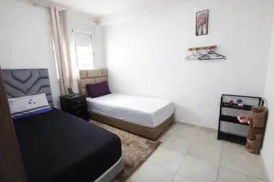 a small bedroom with a bed and a window at Appartement Bouskoura 15 min de l'aéroport mohamed 5 in Casablanca