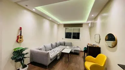 a living room with a couch and a guitar at Bright and cozy studio in Tamaris Beach in Tamaris