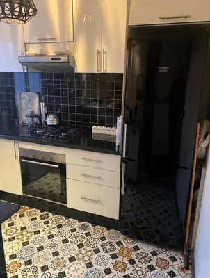 a kitchen with a refrigerator and a tile floor at Bright and cozy studio in Tamaris Beach in Tamaris
