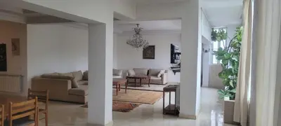 a living room with a couch and a table at Grand appartement avec une belle vue in Rabat