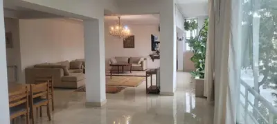 a living room with a couch and a table at Grand appartement avec une belle vue in Rabat