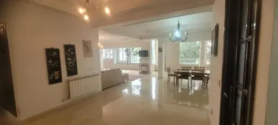 a living room with a couch and a table at Grand appartement avec une belle vue in Rabat