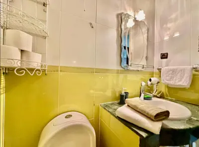 a bathroom with a white toilet and a sink at Rome Avenue Luxury Residence, 3 Chambres in Casablanca