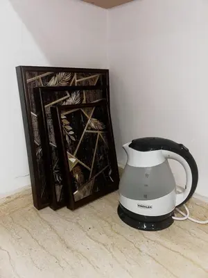 a blender sitting next to a book on the floor at Olive & Orange Modern Studio in Rabat