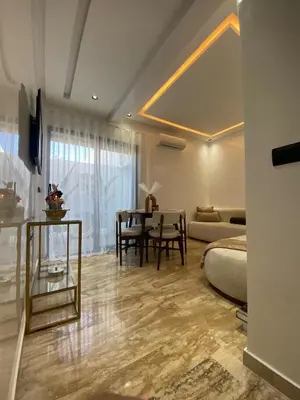 a room with a bed and a table and a couch at Le Miroir in Casablanca