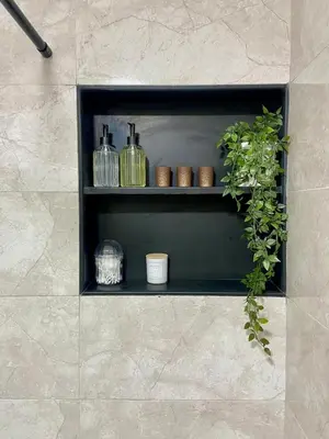 a black shelf with bottles and a plant on it at Le Miroir in Casablanca