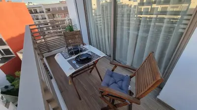 a balcony with a table and chairs on a balcony at Suite Cozy Design Suite Maarif, Close to Ain Diab in Casablanca