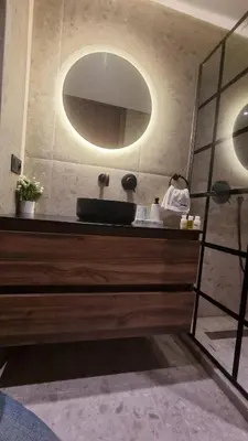 a bathroom with a sink and a mirror at Suite Cozy Design Suite Maarif, Close to Ain Diab in Casablanca
