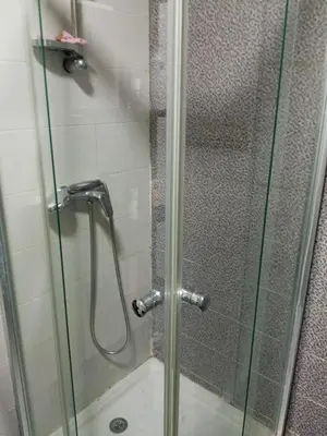a shower with a glass door in a bathroom at La Siesta Beach Appartement in Mohammedia