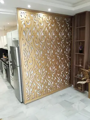 a kitchen with a wall with a wooden screen at La Siesta Beach Appartement in Mohammedia