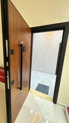 a wooden door with a window in a room at Nice apartment in temara-a in Temara
