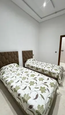 a bedroom with two beds with a bedspread on it at Nice apartment in temara-a in Temara