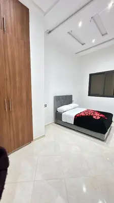 a bedroom with a bed and a flat screen tv at Nice apartment in temara-a in Temara