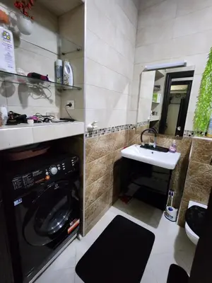 a bathroom with a washing machine and a sink at Apartment or Rooms for couples and single people in luxurious apartment in Rabat