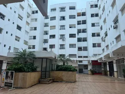 a large white building with palm trees in front of it at Apartment or Rooms for couples and single people in luxurious apartment in Rabat