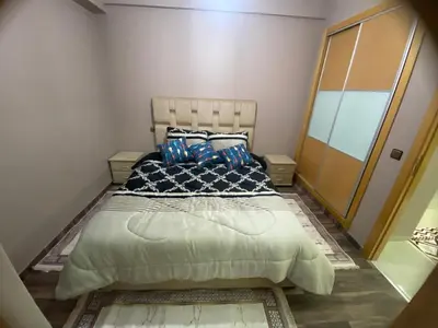 a bedroom with a large bed with pillows on it at Casablanca Comfortable City-Centre Apartment in Casablanca