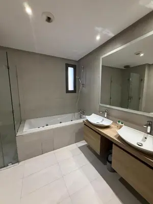 a bathroom with two sinks and a tub and a mirror at Marina de Casablanca in Casablanca