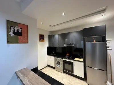 a kitchen with a stainless steel refrigerator and a dishwasher at Modern Apartment in Maarif Princess in Casablanca