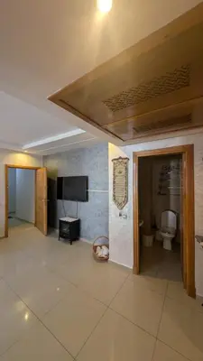 a large room with a toilet and a television at Blue Haven Pool Suites in Pont Blondin