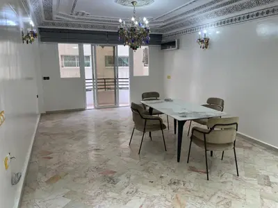 a dining room with a table and chairs and a chandelier at Casablanca Apartments & B&Bs in Casablanca
