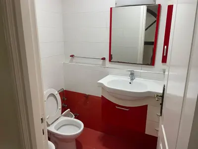 a bathroom with a toilet and a sink and a mirror at Casablanca Apartments & B&Bs in Casablanca