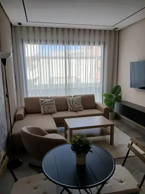 a living room with a couch and a table at BeauLiving Park in Casablanca